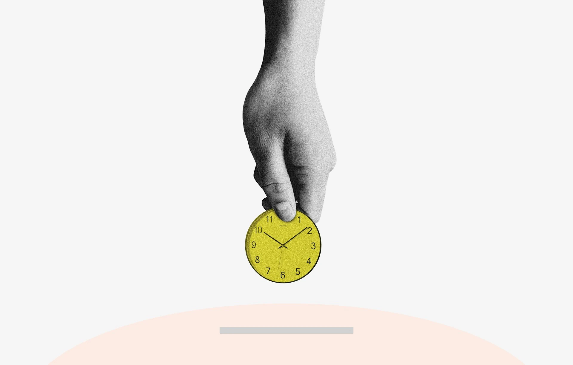 A hand holds a yellow round analog clock.