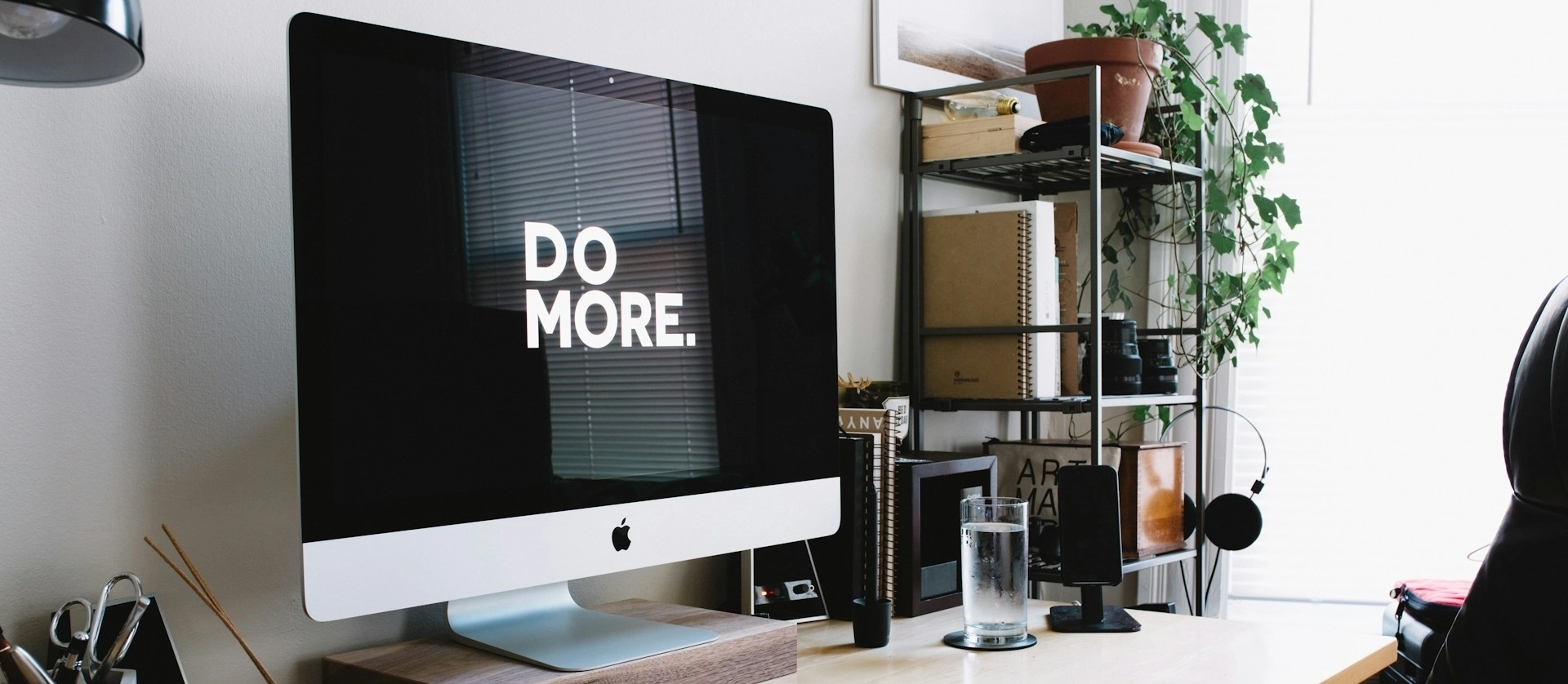 A work monitor with the phrase "Do More" displayed on its screen.
