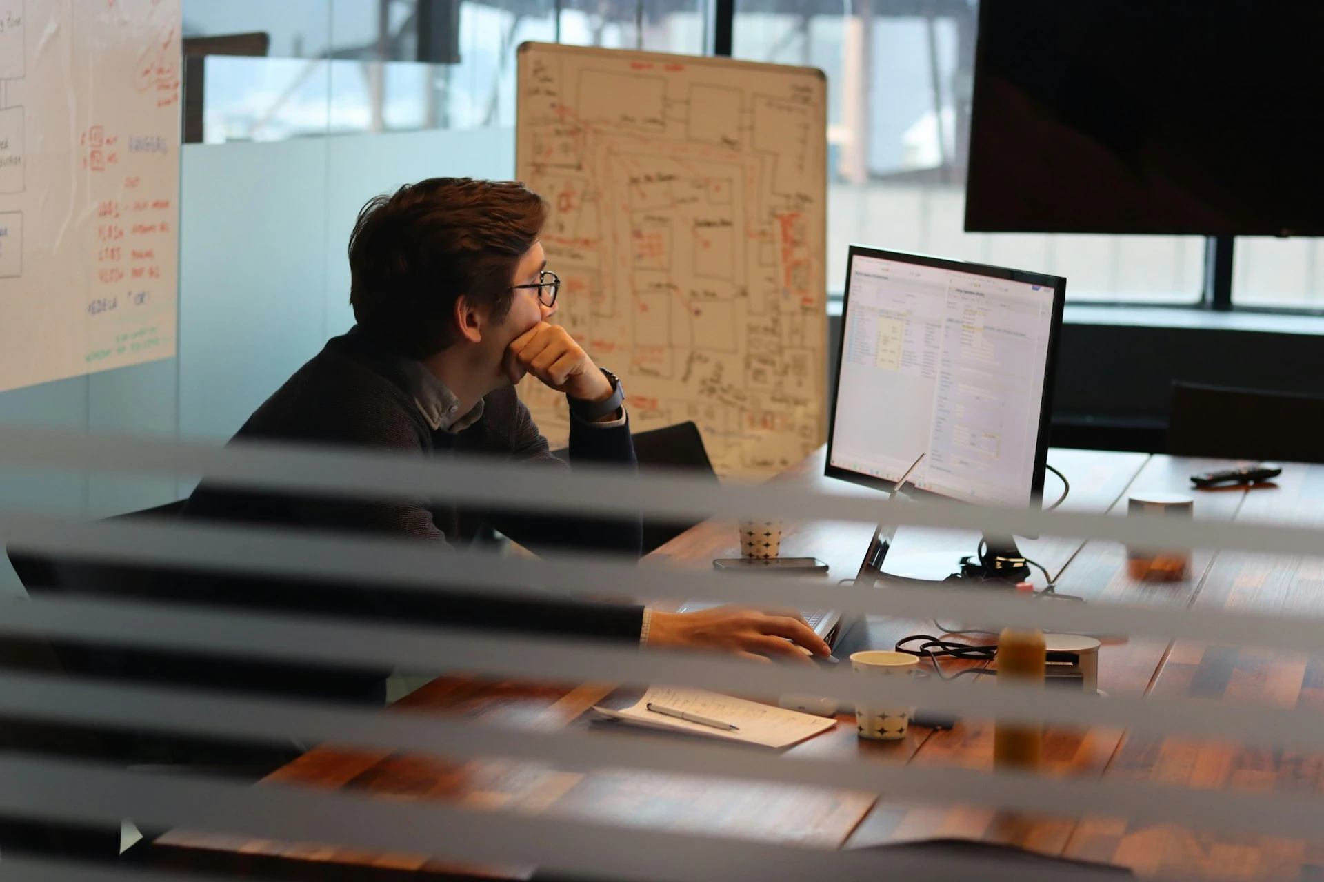 A man working on his computer at the office.
