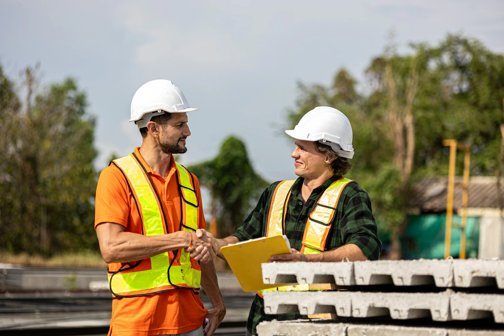 Construction workers shake hands after reaching a deal.