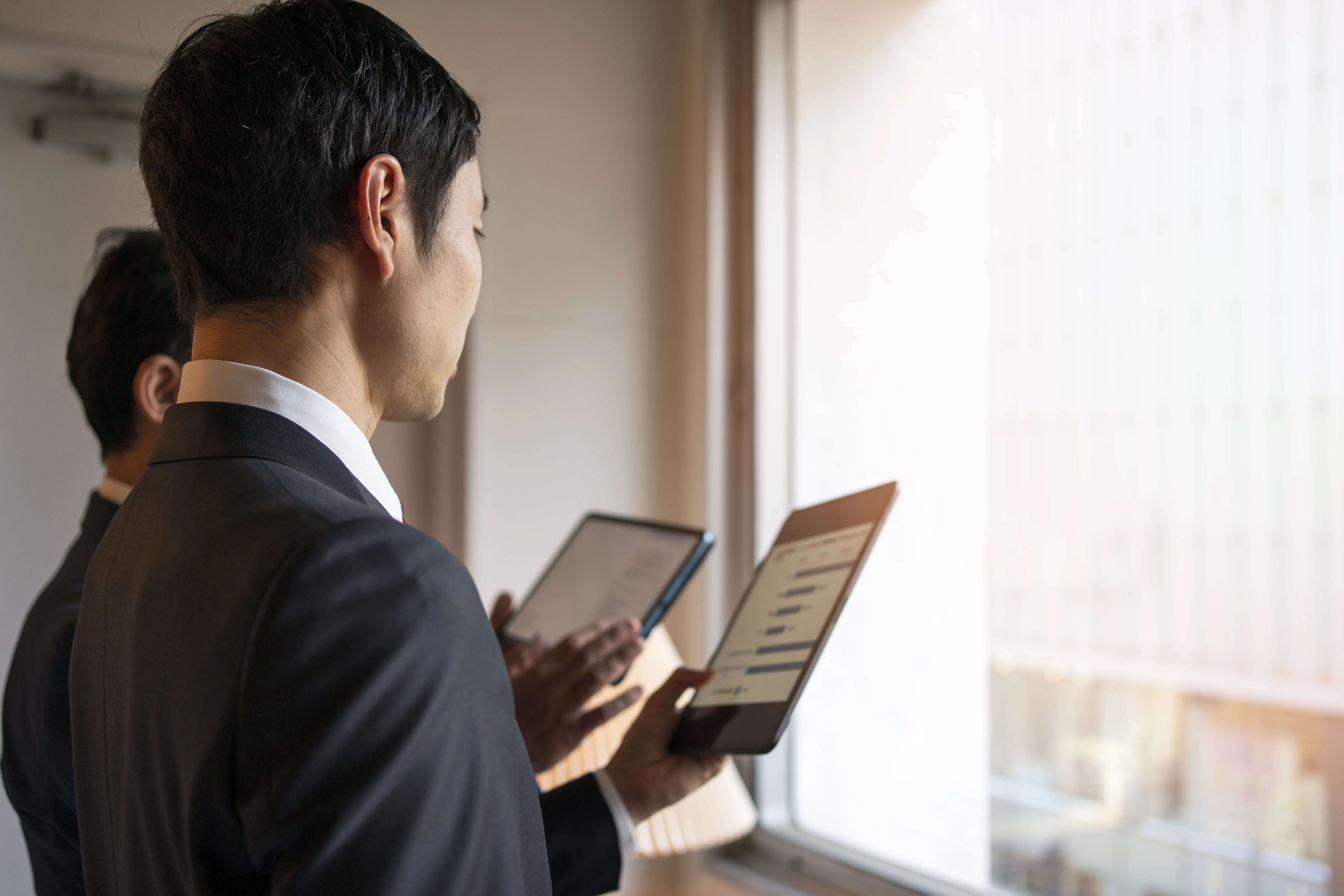 Side view of lawyers working with ipads.