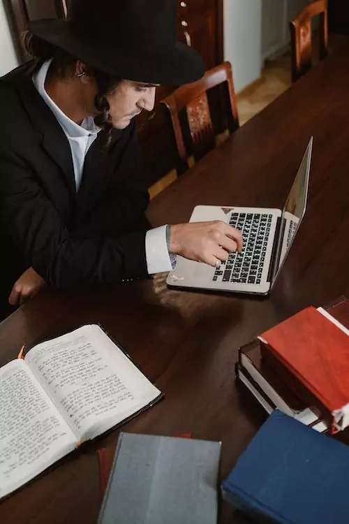 A man working on his computer. Time Tracking Practices in US Churches