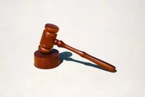 A wooden gavel and block. Photo by Tingey Injury Law Firm on Unsplash