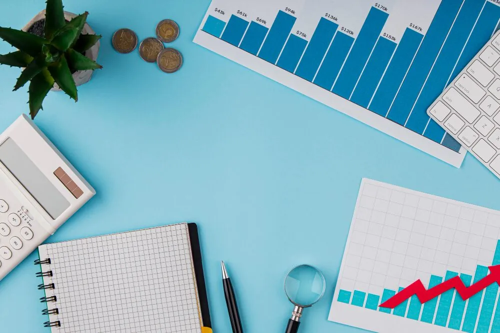 Desk with stationery and graphs.
