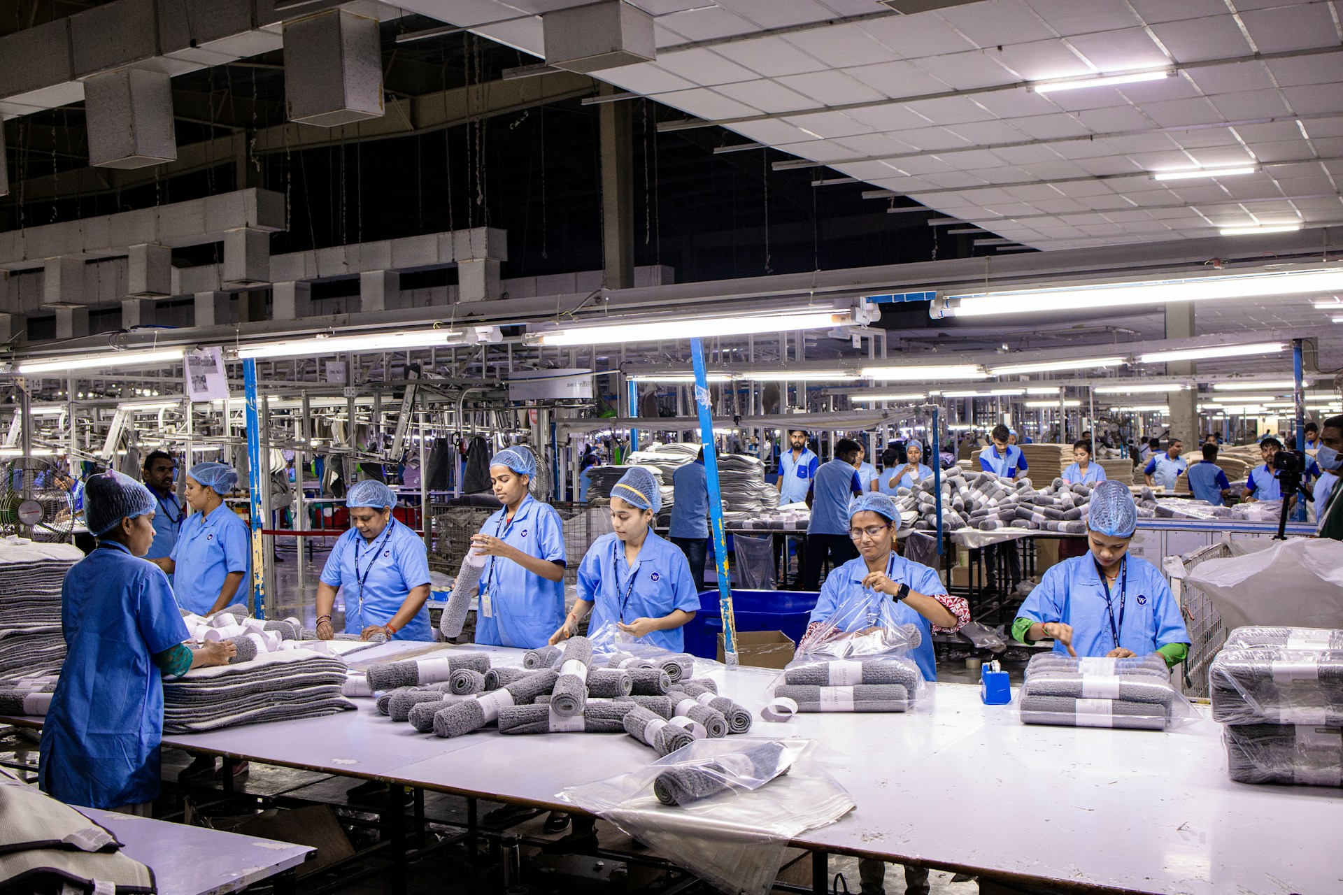 Workers are at an industrial clothing factory.