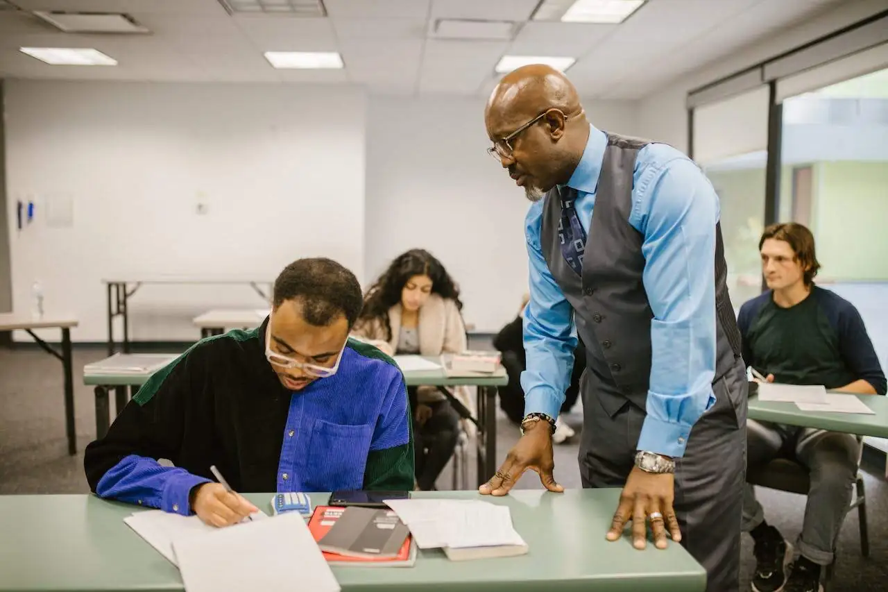 Teacher proctoring his students during an examination.