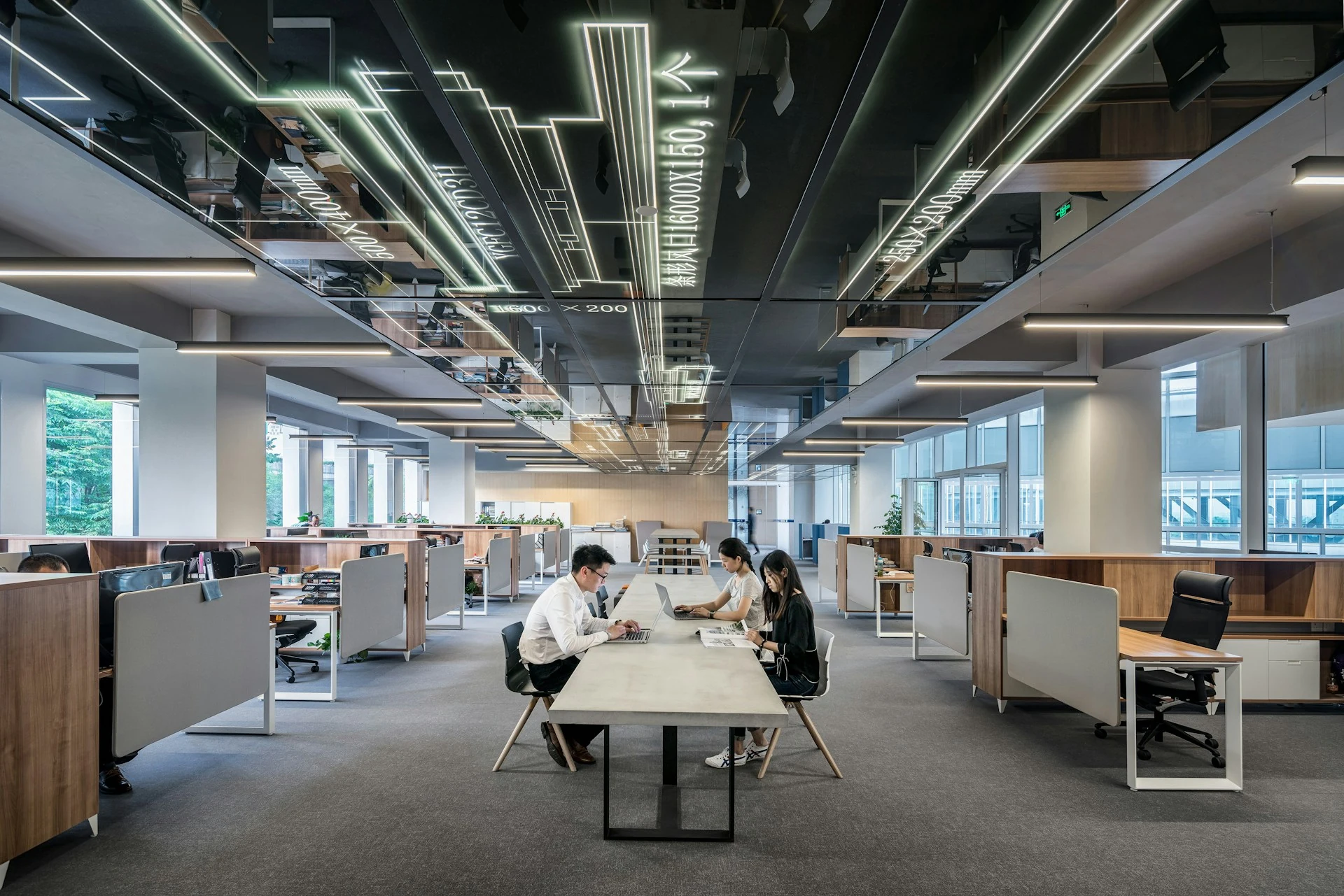 Three people working at the office.