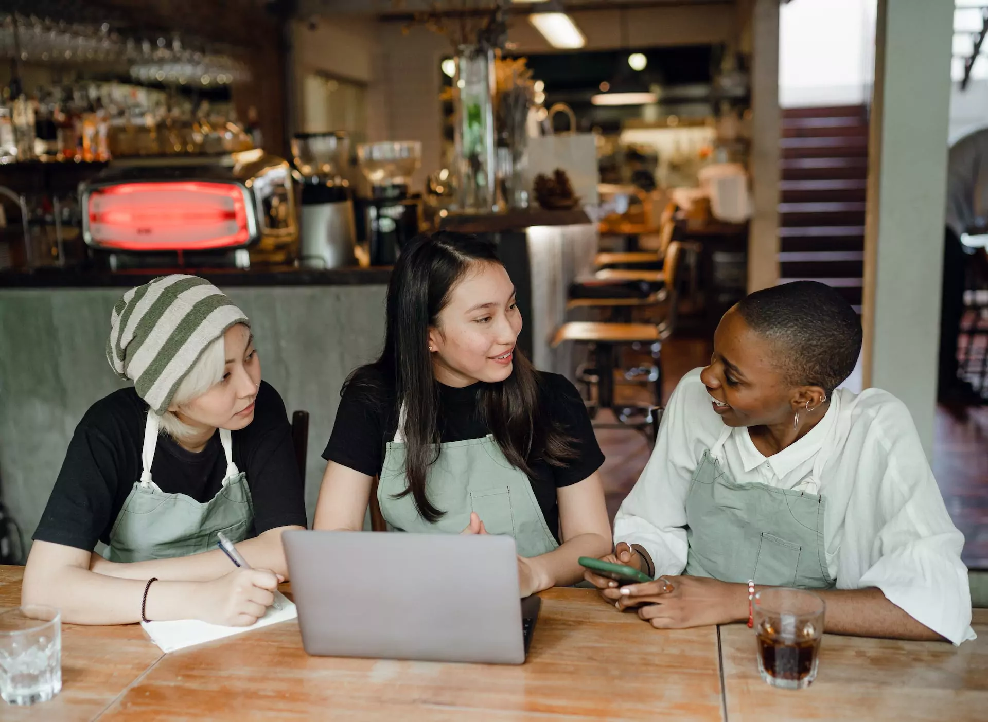 Restaurant workers having a meeting with the restaurant manager.