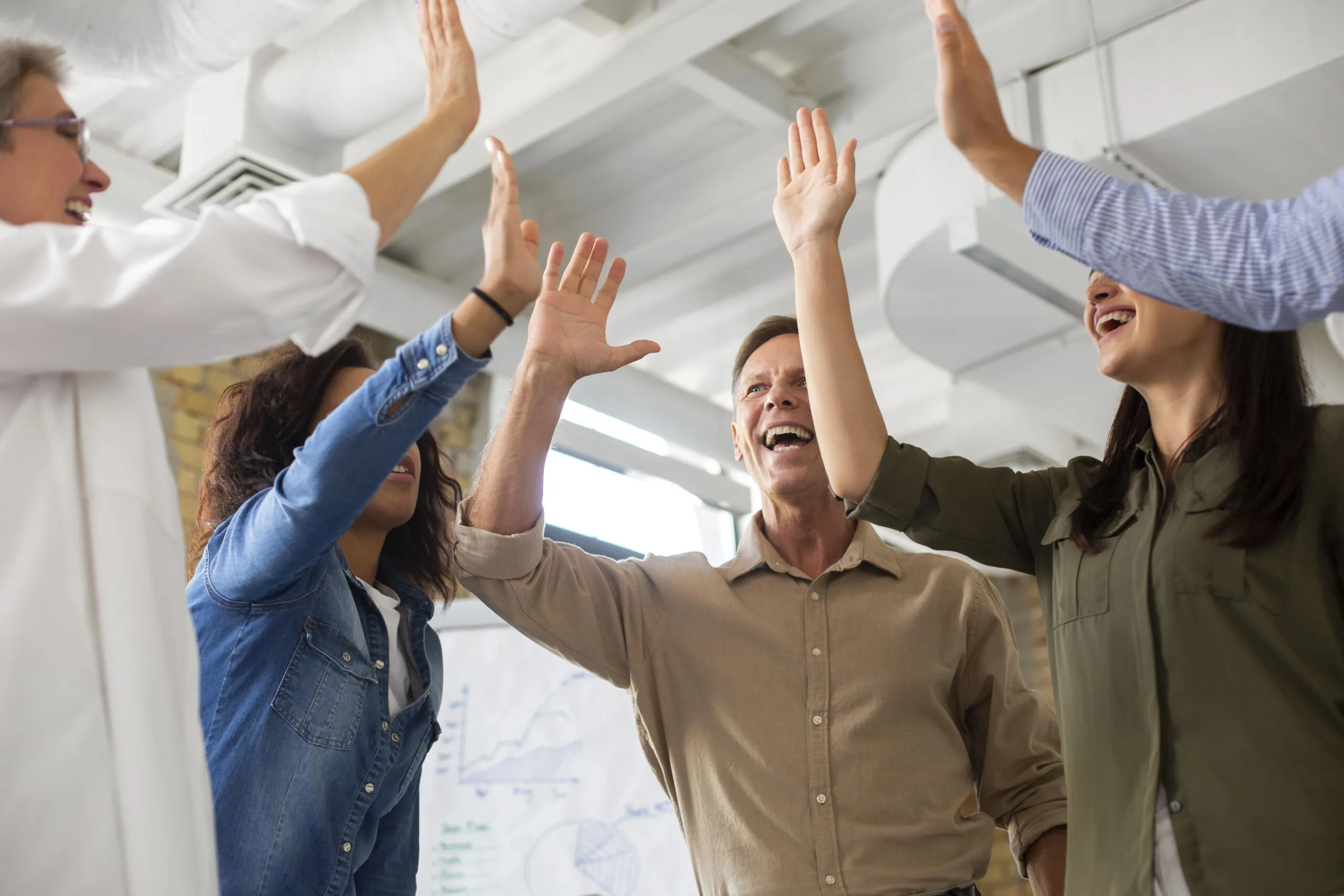 Group of people high-fiving.