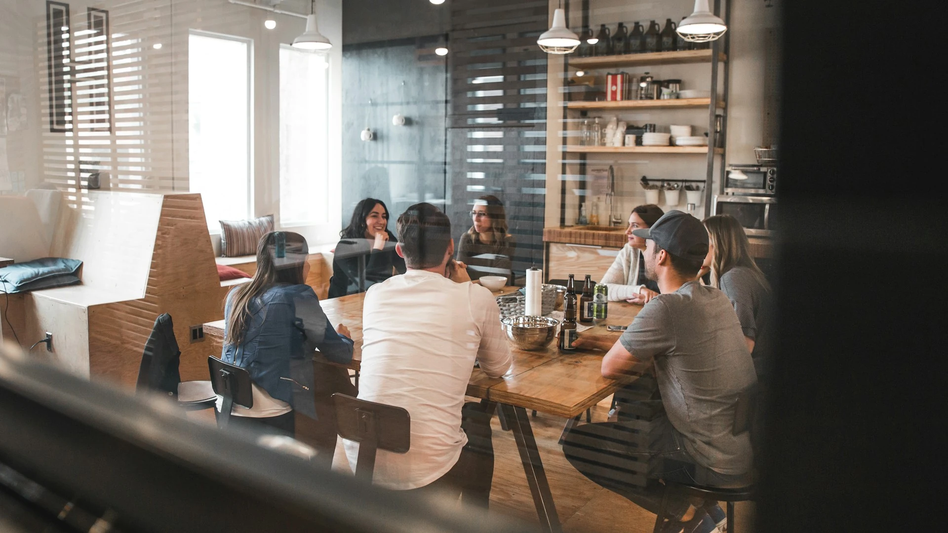 A group of employees seated around an office table.