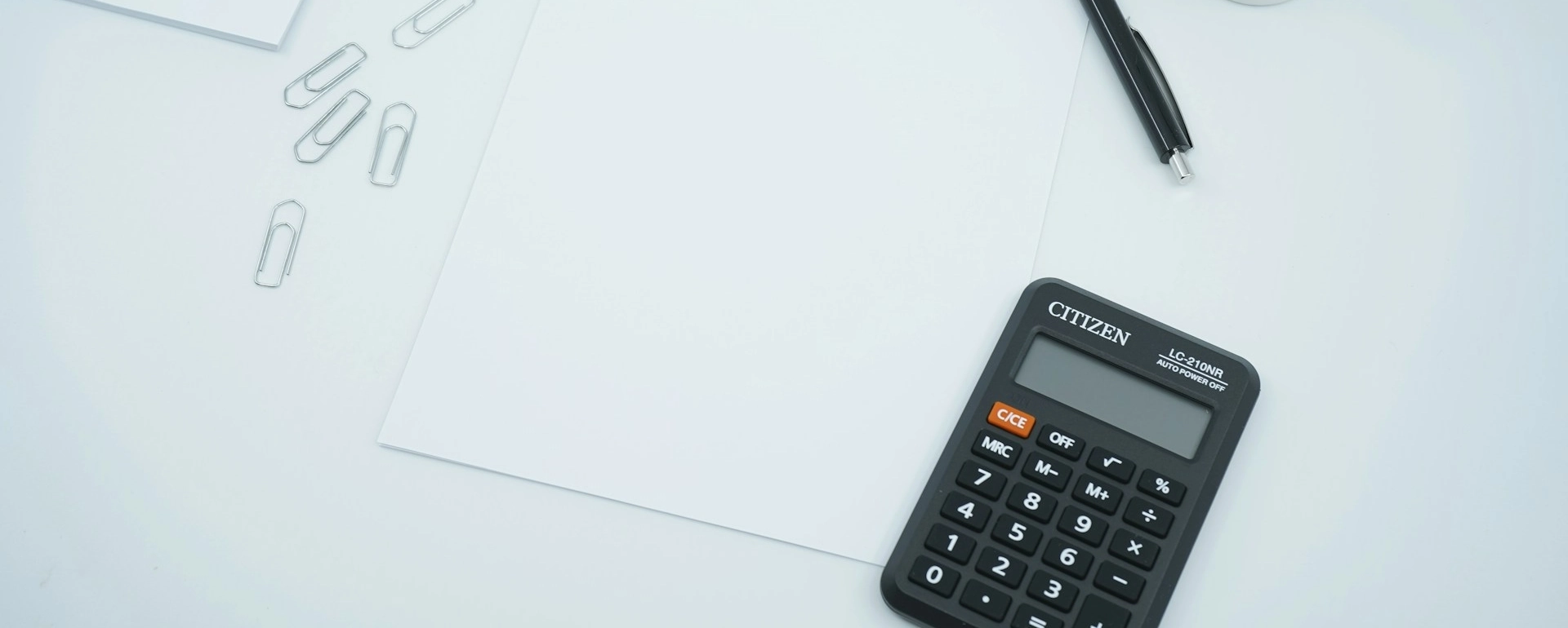 A calculator next to a piece of paper