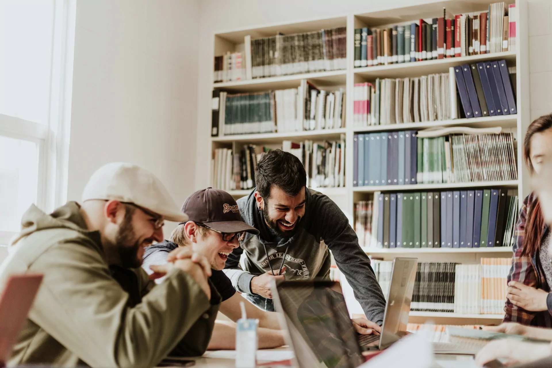 A group of employees laughing at the office. Photo by Priscilla Du Preez 🇨🇦 on Unsplash