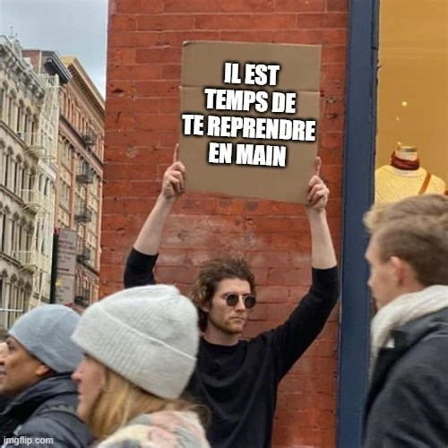 Un homme tenant une pancarte avec un message pour se reprendre en main