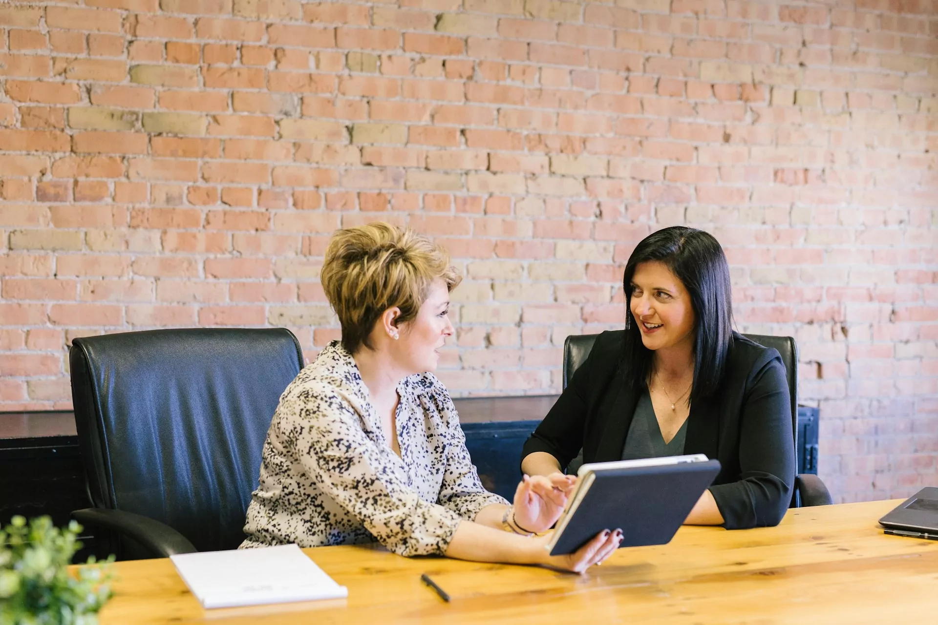 Two salaried employees discussing something at work.