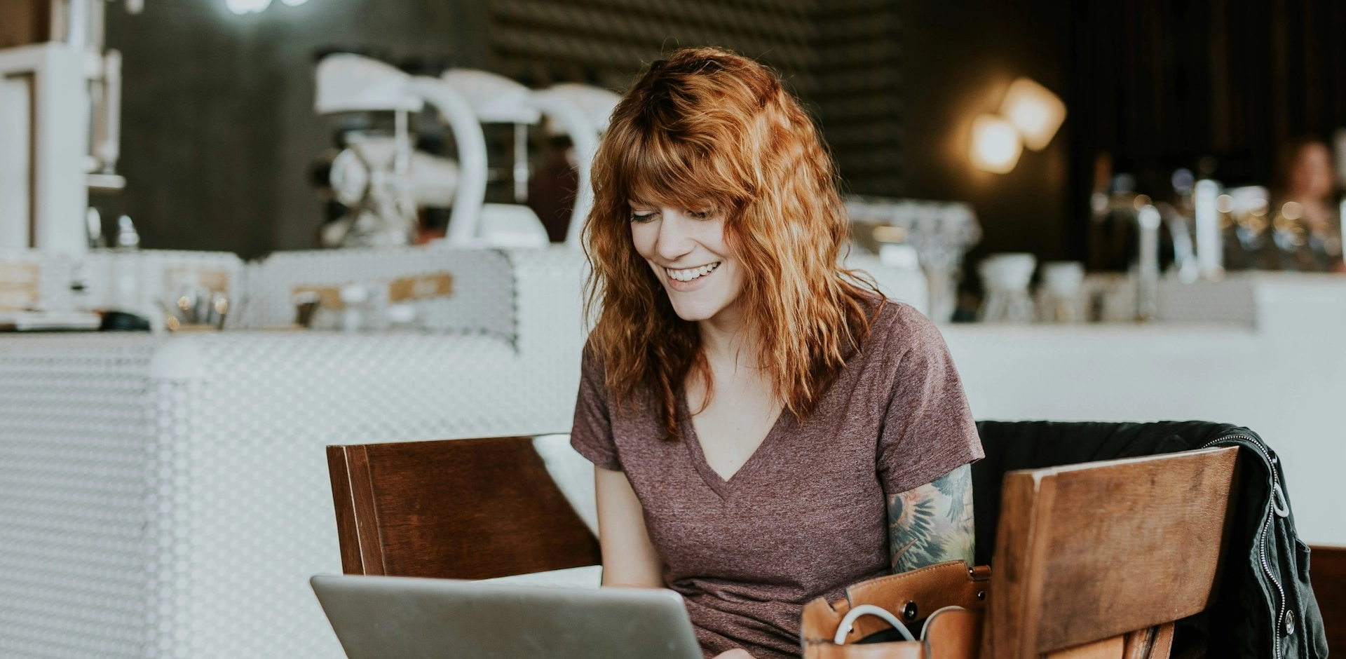 A female freelancer working at a cafe. Photo by Brooke Cagle on Unsplash