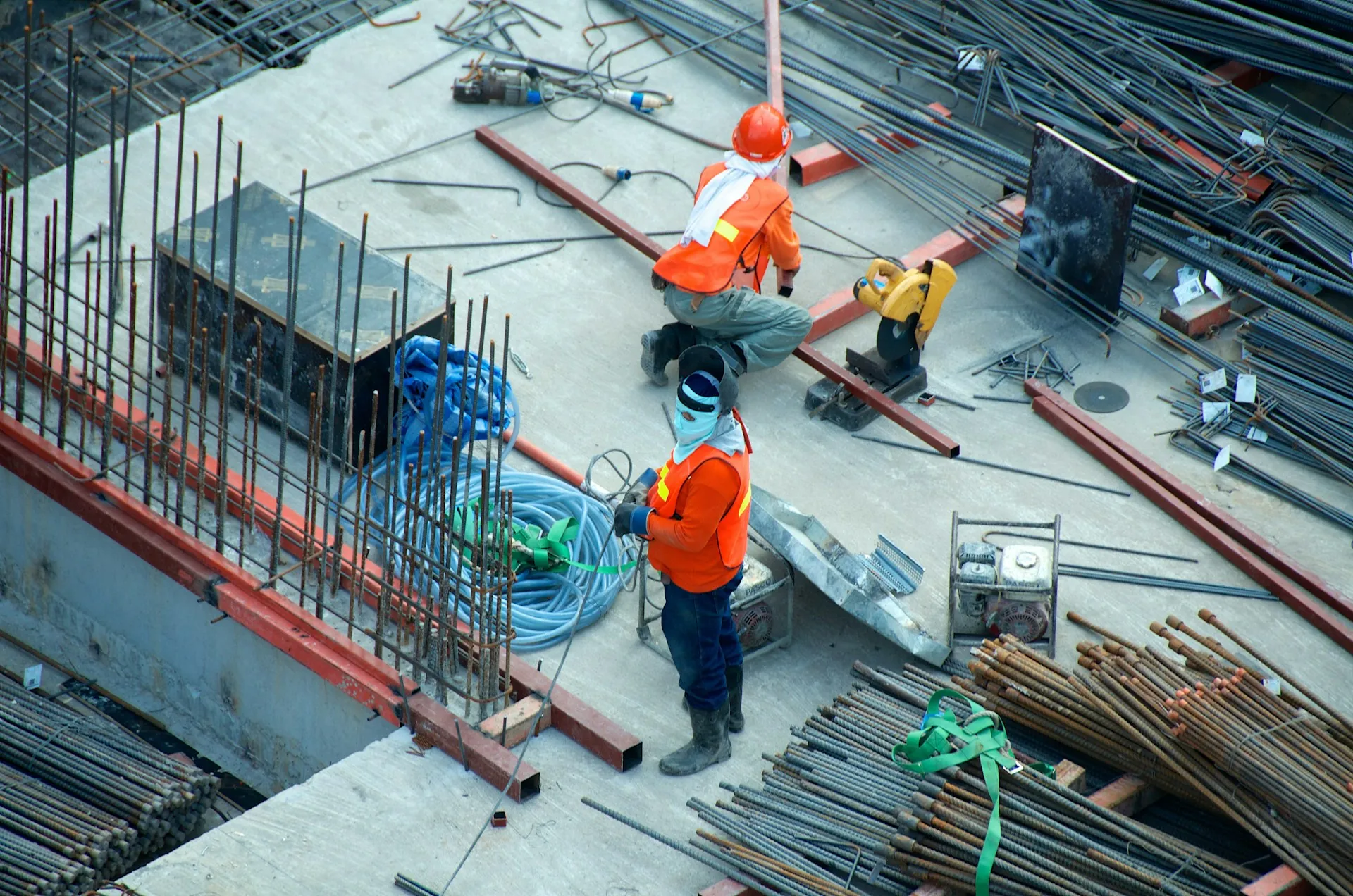 Un grupo de trabajadores de la construcción que realizan diversas tareas en una obra.