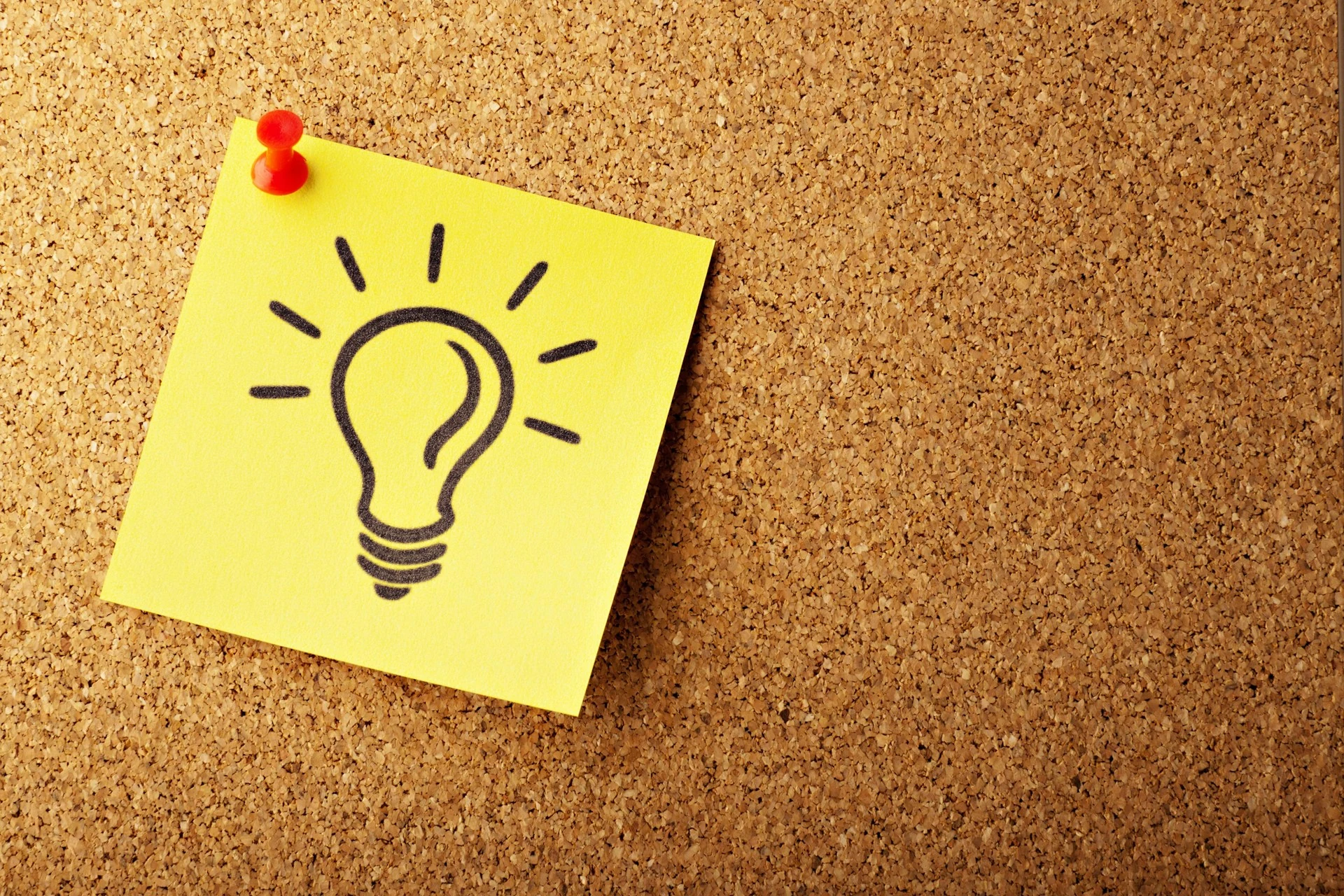 A sticky note with a light bulb drawn on it