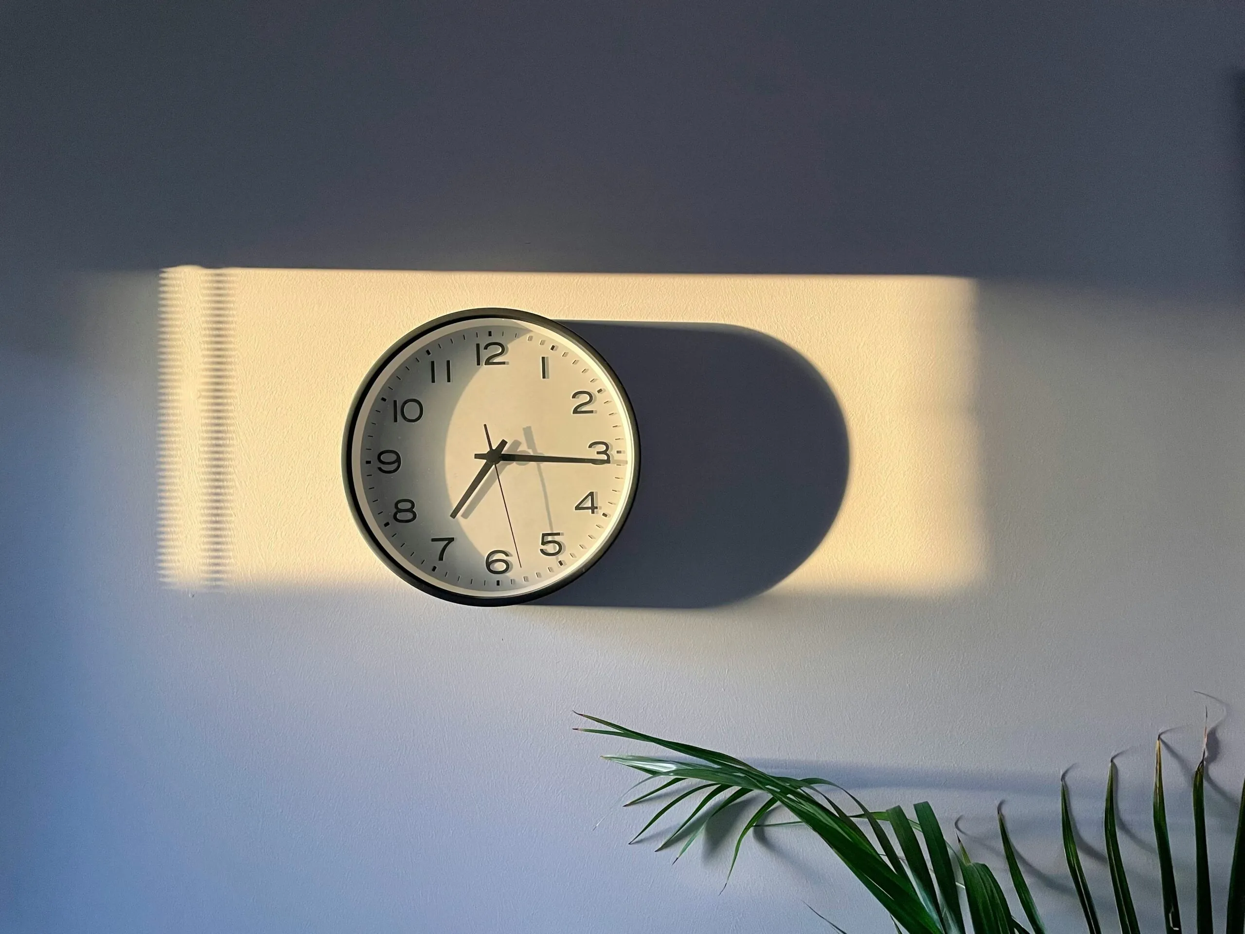 Wall clock with daylight shining on it