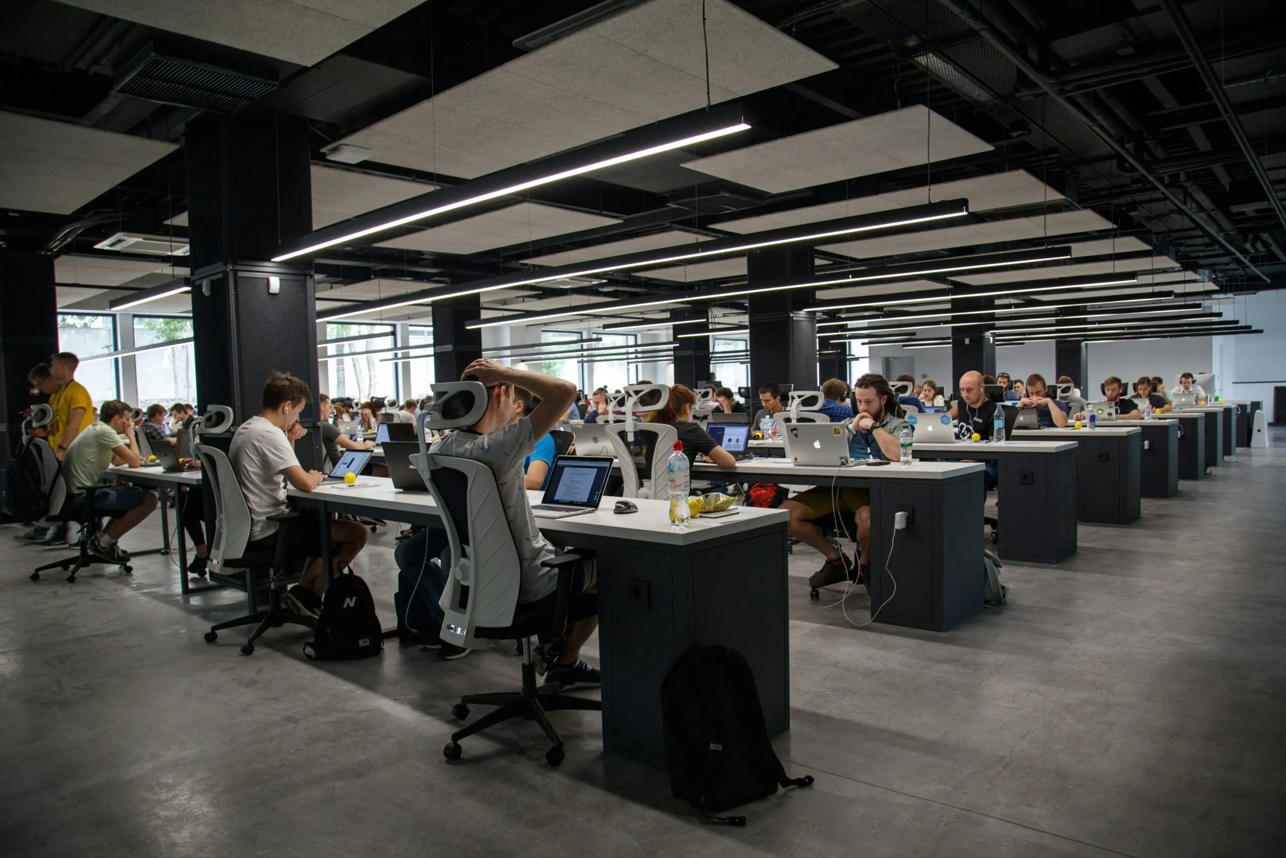Landscape of people sitting at desks working in an office