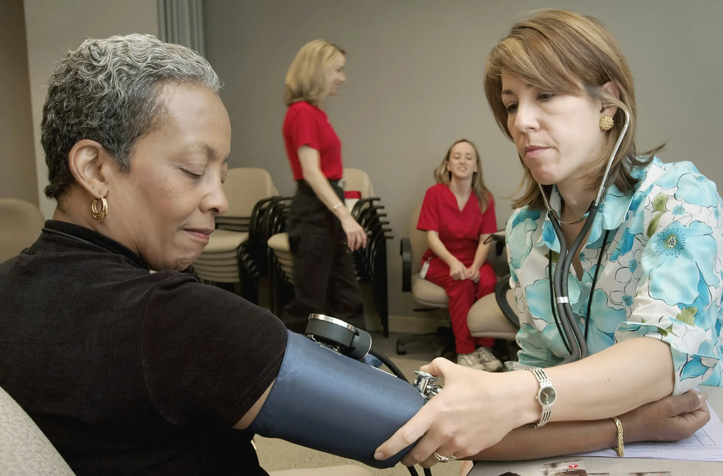 Nurse treating blood patient at health clinic